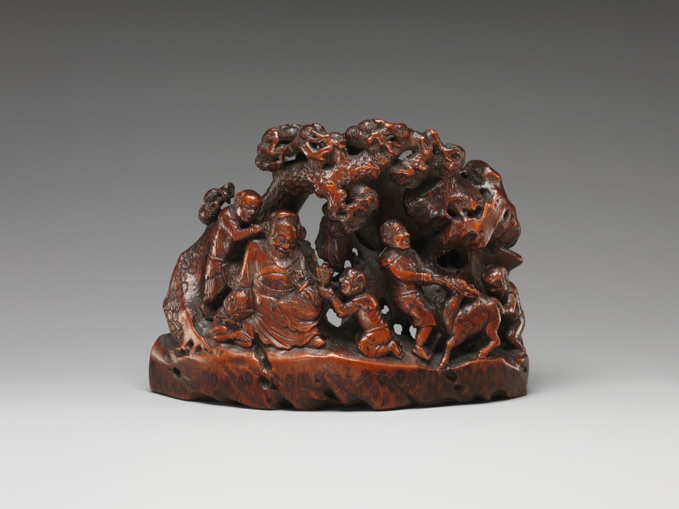Demon queller Zhong Kui with demons, bamboo carving